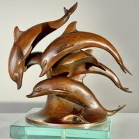 Alt text: Bronze sculpture of a group of dolphins