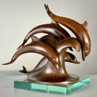 Alt text: Bronze sculpture of a group of dolphins