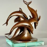 Alt text: Bronze sculpture of a group of dolphins