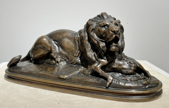 Alt text: sculpture of a lion over a dead animal