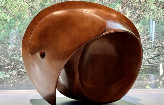 Alt text: bronze, oval shaped sculpture