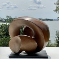 Alt text: bronze, oval shaped sculpture