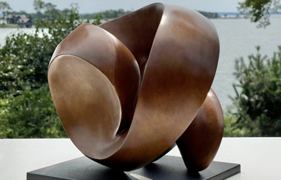 Alt text: bronze, oval shaped sculpture