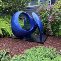 Alt text: Blue abstract sculpture, outdoors