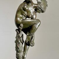 Alt text: Bronze sculpture of a woman looking down