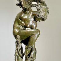 Alt text: Bronze sculpture of a woman looking down