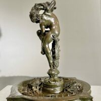 Alt text: Bronze sculpture of a woman looking down