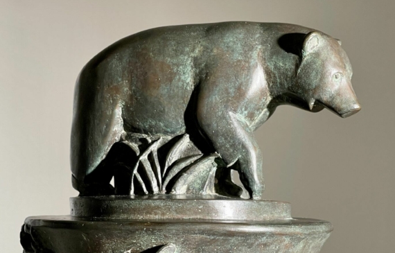 Alt text: Bronze sculpture of a bear on a pedestal