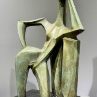 Alt text: Green sculpture of a standing woman