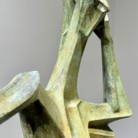 Alt text: Green sculpture of a standing woman