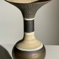 Alt text: Brown ceramic vase