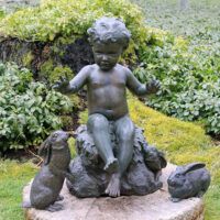 Alt text: Bronze outdoor sculpture of a child with two rabbits