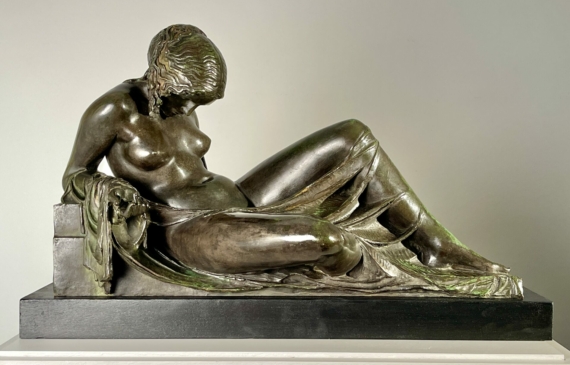 Alt text: Bronze sculpture of a reclining woman