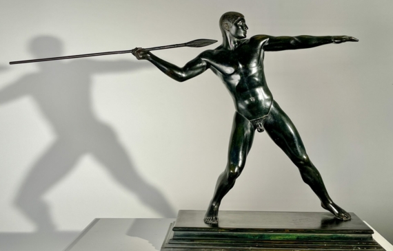 Alt text: Bronze sculpture of man with a spear