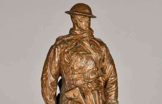 Alt text: Bronze sculpture of a standing soldier