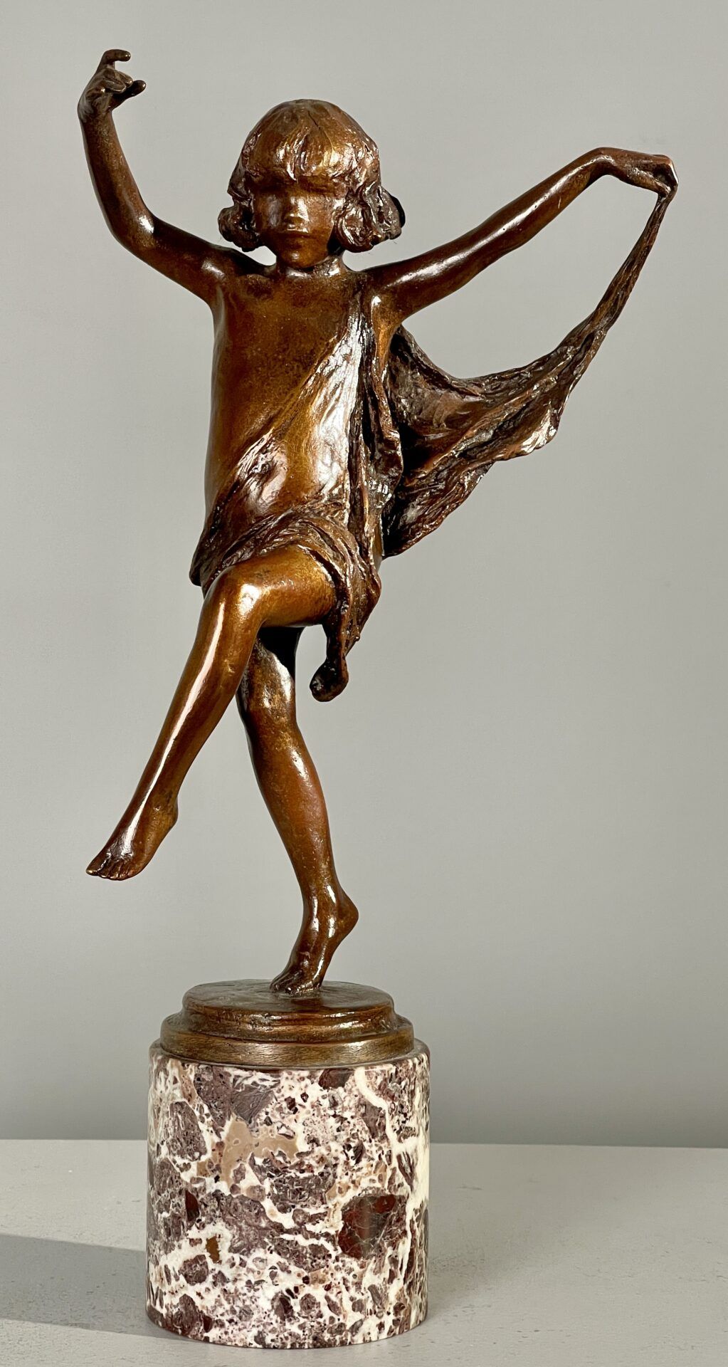 Alt text: Bronze sculpture of a girl