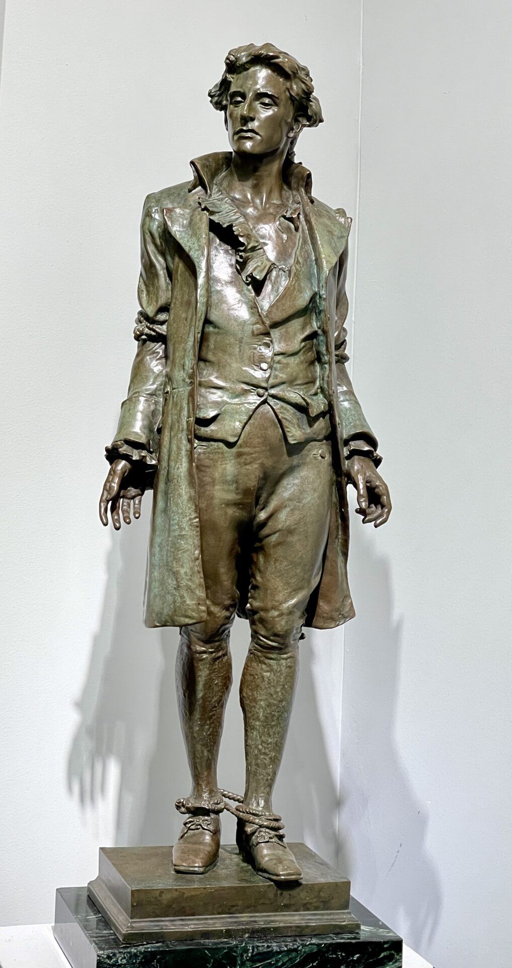 Alt text: Bronze sculpture of a standing man