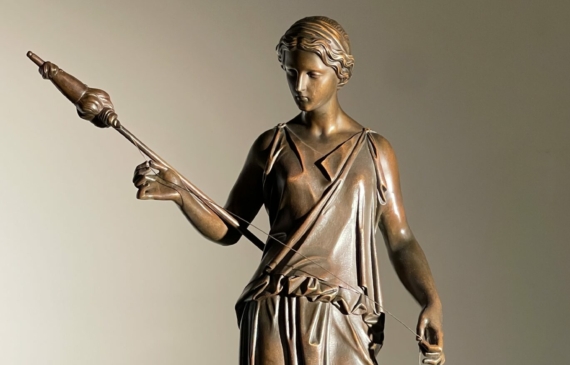 Alt text: Bronze sculpture of a standing woman