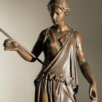 Alt text: Bronze sculpture of a standing woman