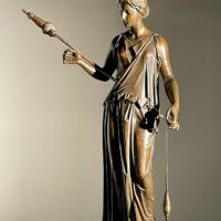 Alt text: Bronze sculpture of a standing woman