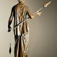 Alt text: Bronze sculpture of a standing woman