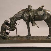 Alt text: Bronze sculpture of a figure kneeling in front of a horse