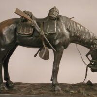 Alt text: Bronze sculpture of a figure kneeling in front of a horse