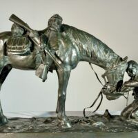 Alt text: Bronze sculpture of a figure kneeling in front of a horse
