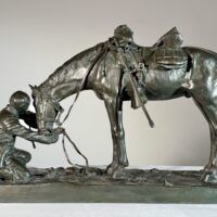 Alt text: Bronze sculpture of a figure kneeling in front of a horse