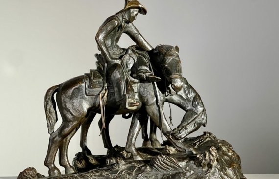 Alt text: Bronze sculpture of a man with horses