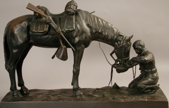 Alt text: Bronze sculpture of a figure kneeling in front of a horse