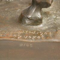 Alt text: Bronze sculpture, signature detail