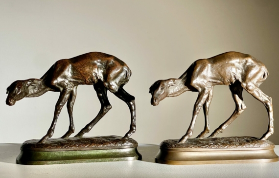 Alt text: Two bronze sculpture of fawns, side by side