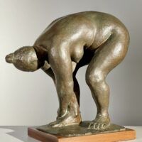 Alt text: Bronze sculpture of a nude woman bending over