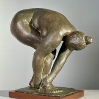 Alt text: Bronze sculpture of a nude woman bending over