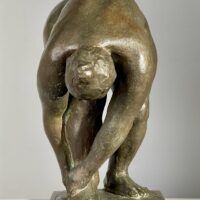 Alt text: Bronze sculpture of a nude woman bending over