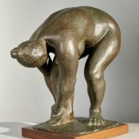 Alt text: Bronze sculpture of a nude woman bending over