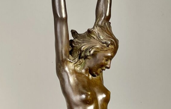 Alt text: Bronze sculpture of a standing woman