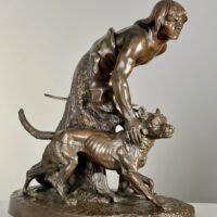 Alt text: Bronze sculpture of a figure with a dog