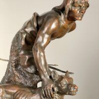 Alt text: Bronze sculpture of a figure with a dog