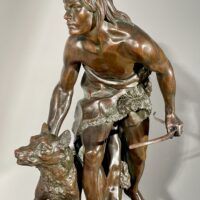 Alt text: Bronze sculpture of a figure with a dog