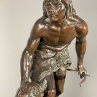 Alt text: Bronze sculpture of a figure with a dog