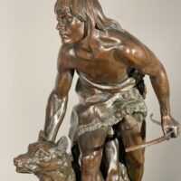 Alt text: Bronze sculpture of a figure with a dog