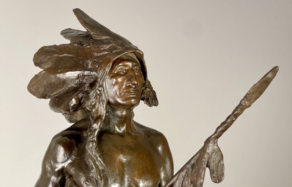 Alt text: Bronze sculpture of a Native American man on a horse