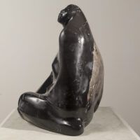 Alt text: Black marble sculpture of a seated woman