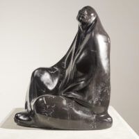 Alt text: Black marble sculpture of a seated woman