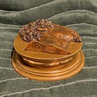 Alt text: Bronze relief sculpture of a man's head
