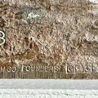 Alt text: Bronze sculpture, inscription detail