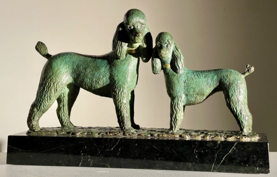 Alt text: Bronze sculpture of two poodles