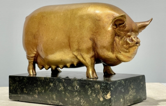 Alt text: Bronze sculpture of a pig